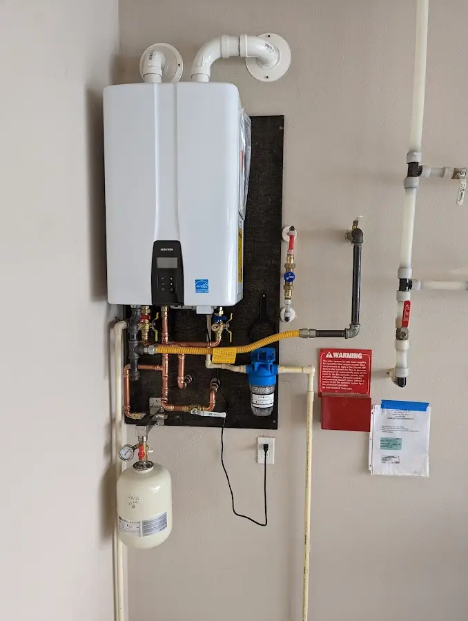 Professional plumber installing copper piping in a Philadelphia home